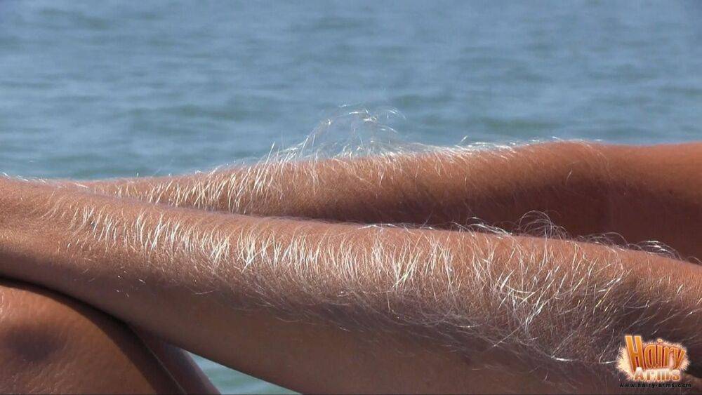 MILF Lori Anderson naked on the beach to show off her long arm hair in the sun - #12