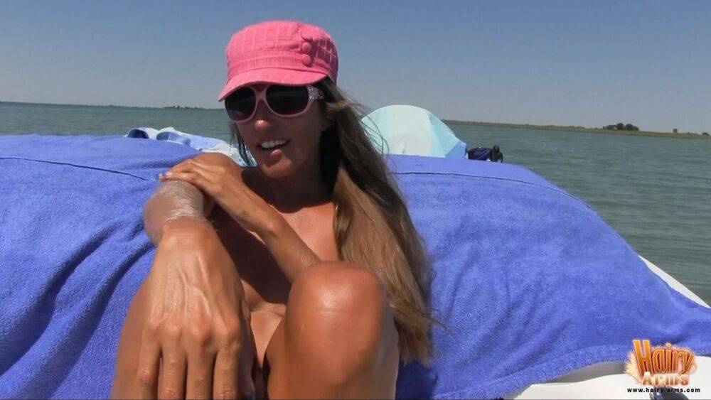 MILF Lori Anderson naked on the beach to show off her long arm hair in the sun - #2