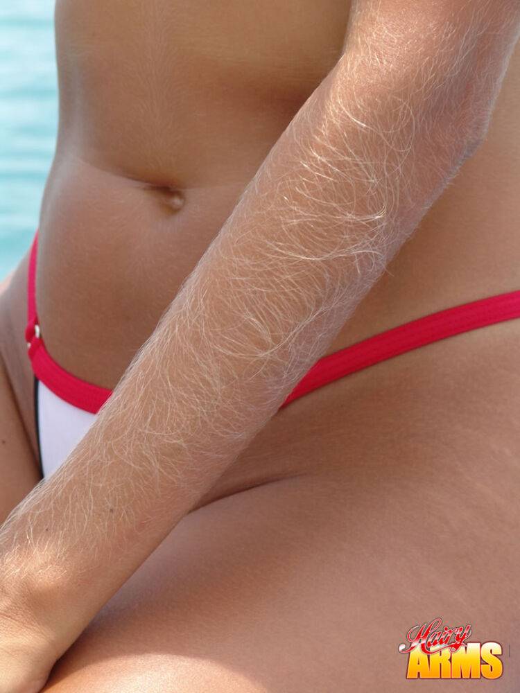 Middle-aged amateur with hairy arms models in a bikini next to the ocean - #4