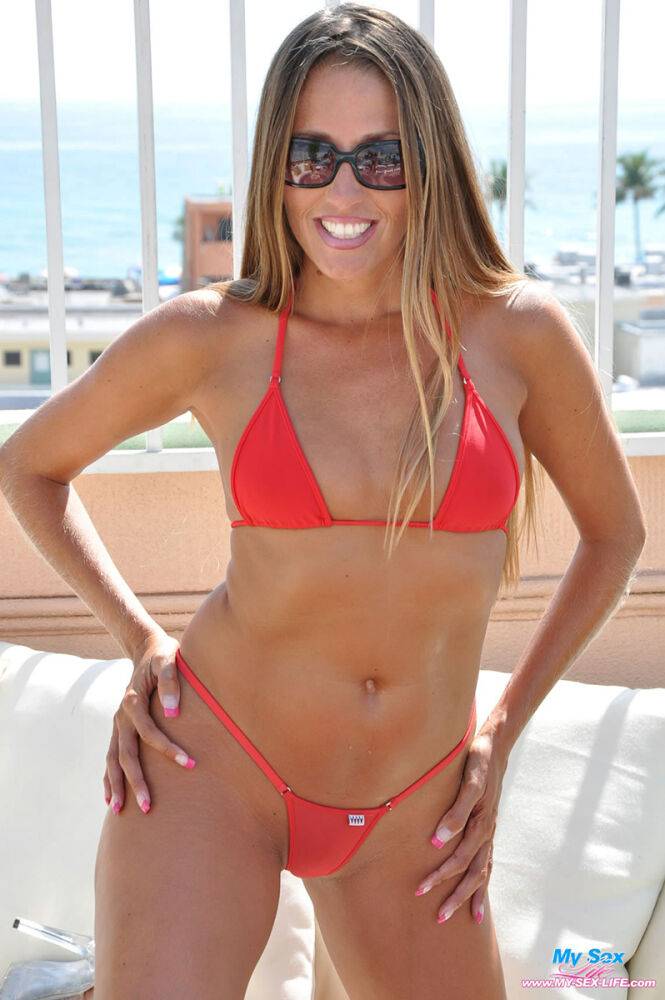 Amateur model Lori Anderson frees tits and ass from red bikini in sunglasses - #13