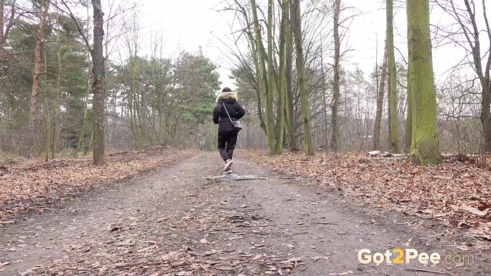 Solo girl Natasha Ink squats for a pee on a dirt road in glasses and a coat - #4