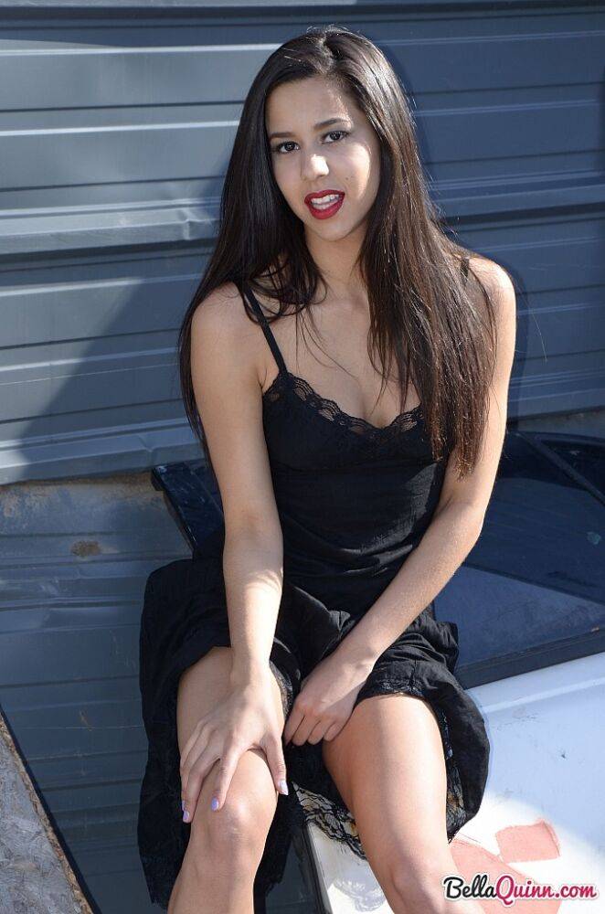 Dark haired amateur Bella Quinn models a black dress outdoors in junkyard - #2