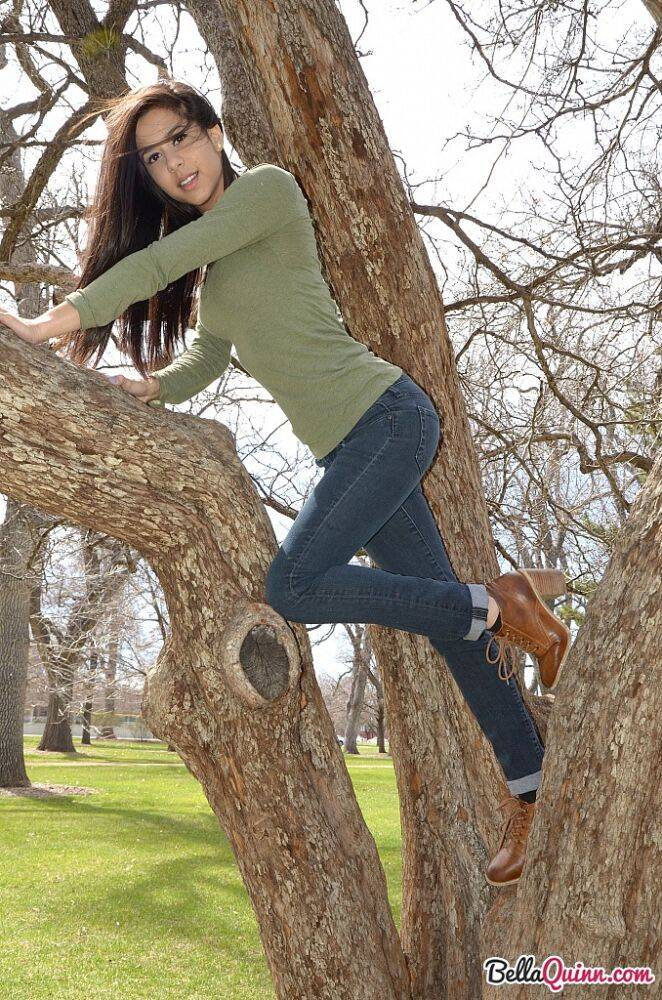 Latina chick Bella Quinn climbs a tree in the park wearing a sweater and jeans - #10