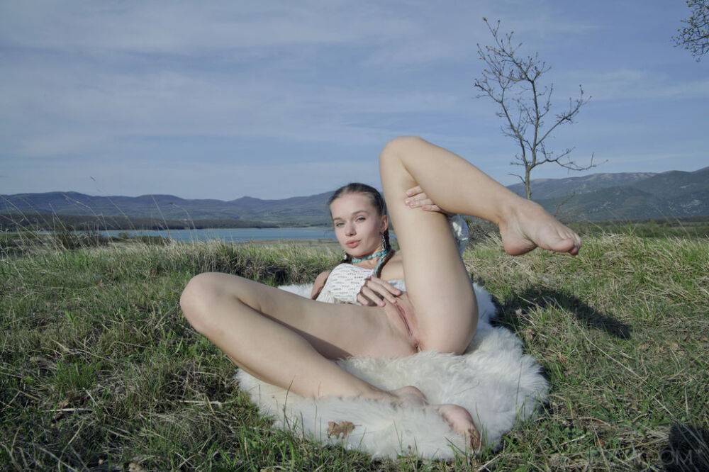 Charming young girl Milena D plays with her pussy in a field with a water view - #6