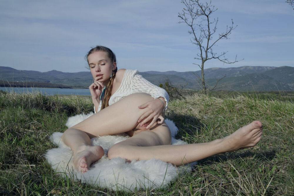 Charming young girl Milena D plays with her pussy in a field with a water view - #12