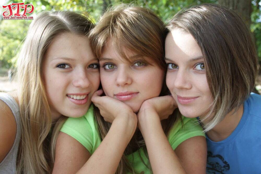 Three young looking girls gets naked on a wooden bench in the countryside - #10