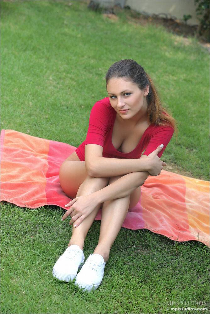 Cute brunette in sneakers posing naked on her knees on the front lawn - #3