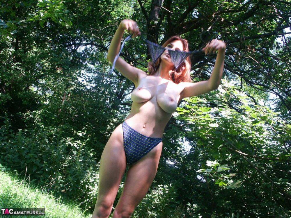 Hot redhead amateur Vanessa disrobes under a tree to air her big saggy tits - #4