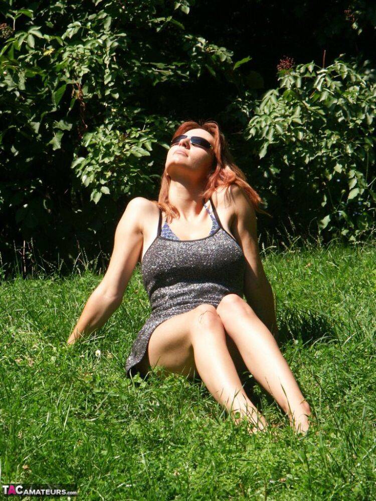 Hot redhead amateur Vanessa disrobes under a tree to air her big saggy tits - #7