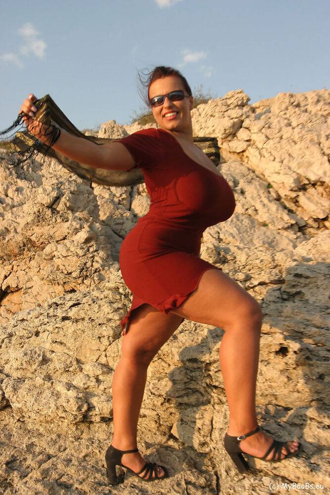 Solo girl Aneta Buena displays her giant tits on a windy peak - #15