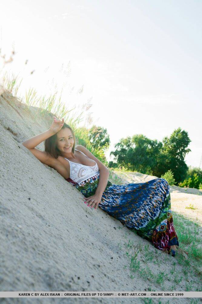 Busty teen Karen C sports a closeup of her bald twat on a sandy bank - #12