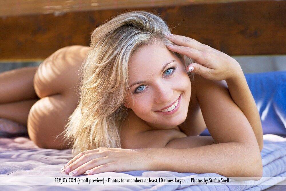 Blonde with blue eyes admires herself in a mirror while posing nude - #10