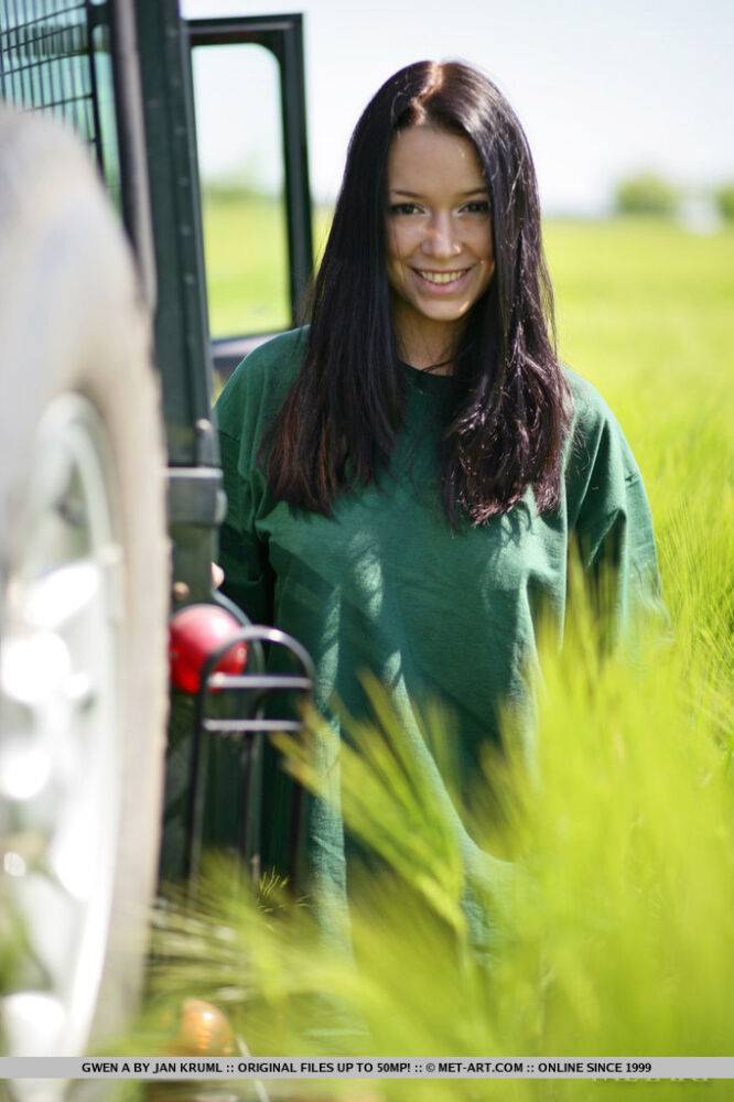 Dark haired girl Gwen A strips naked on top of a Land Rover on safari - #11