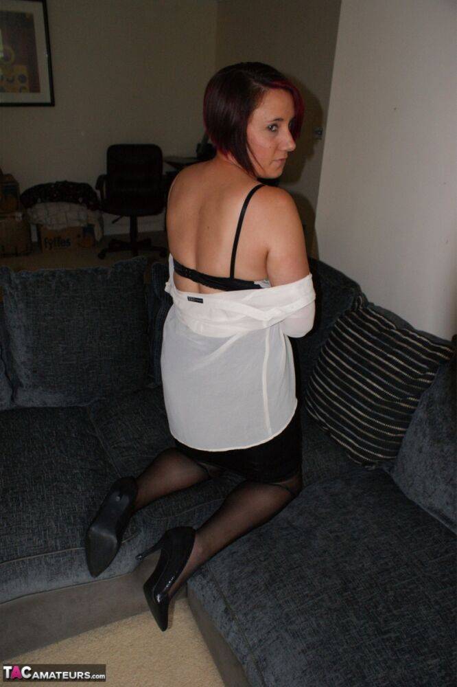 Redhead secretary Sara Banks exposes her upskirt panties and bra on a sofa - #4