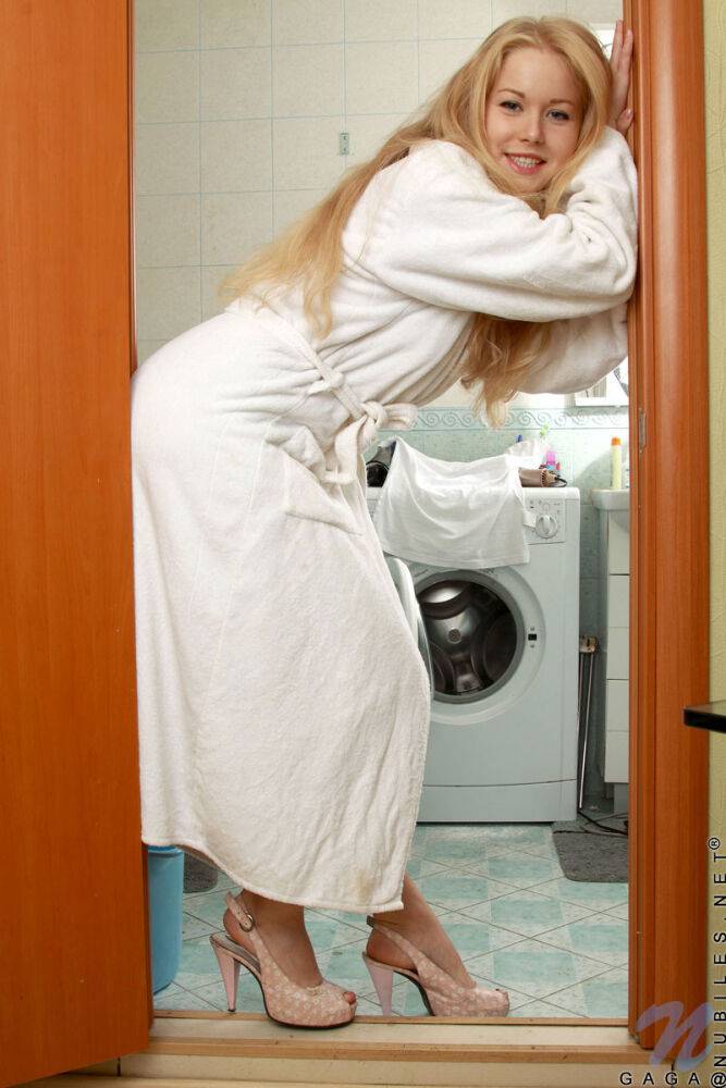 Blonde teen removes a robe as she gets naked in the bathroom to shower - #1