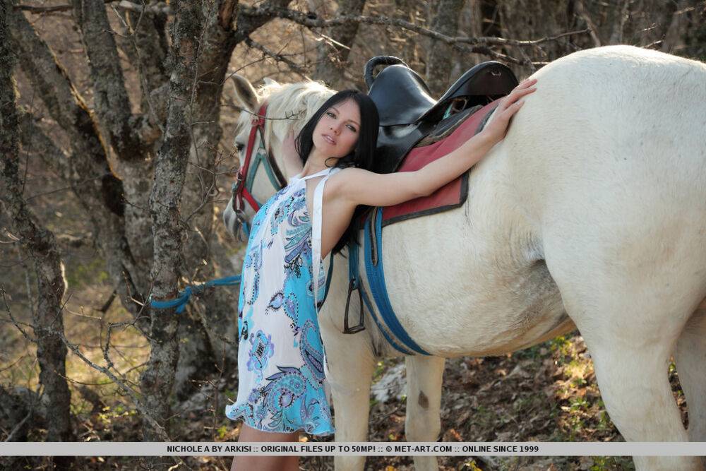 Dark haired teen Nichole A dismounts her horse in woods to pose totally naked - #2