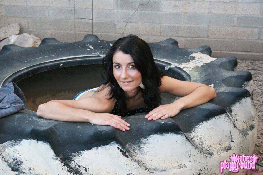 Dark-haired teen Stacy gets naked on a used tire in a safe for work manner - #10