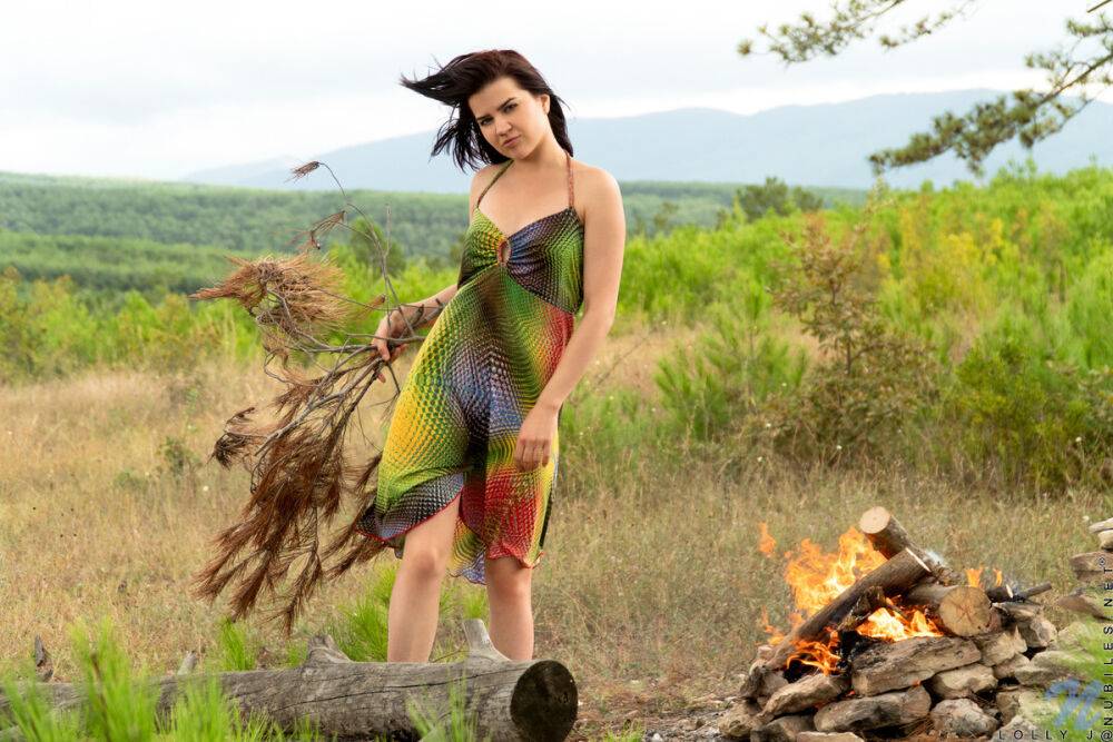 Dark haired girl Lolly J builds a fire in a field before stripping naked - #5