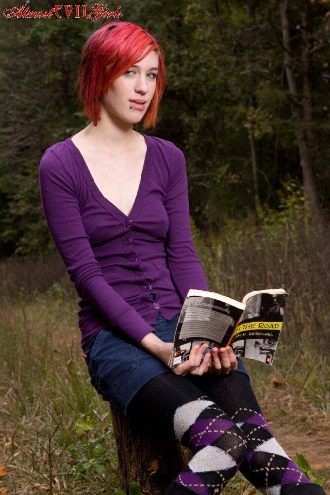 Redhead chick exposes upskirt pussy and tits while sitting on a stump - #4