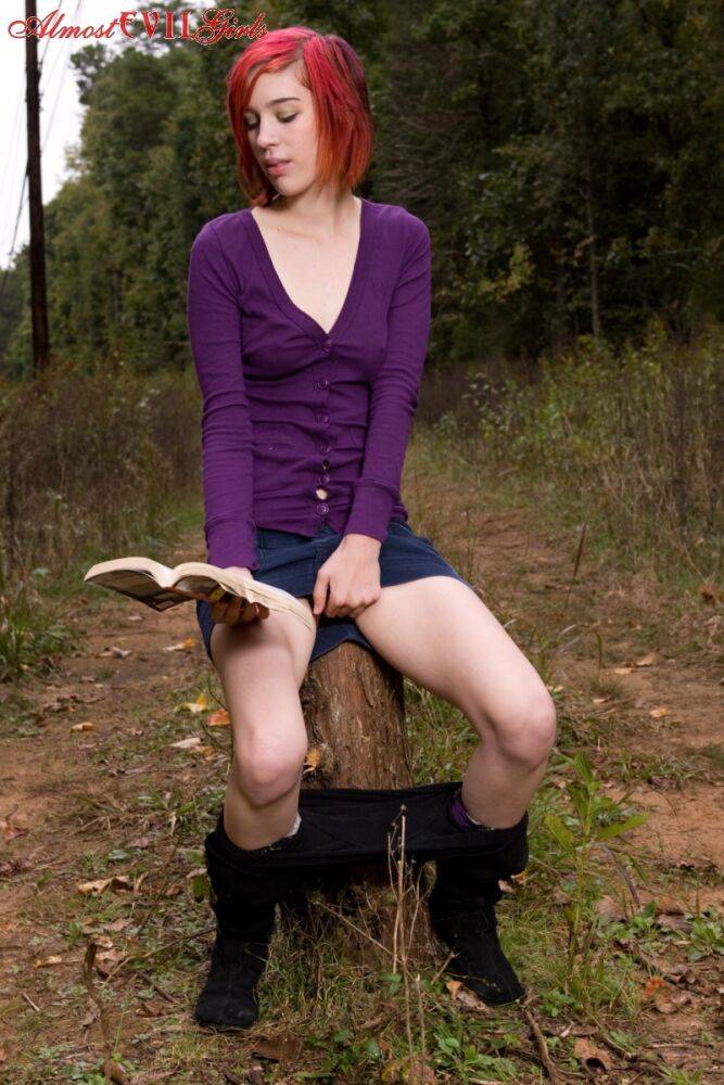 Redhead chick exposes upskirt pussy and tits while sitting on a stump - #13