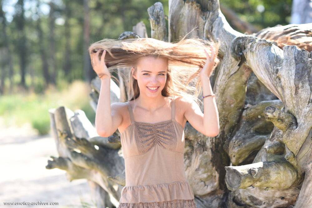 Sweet teen Maxa sets her tan lined body free near a fallen tree - #4