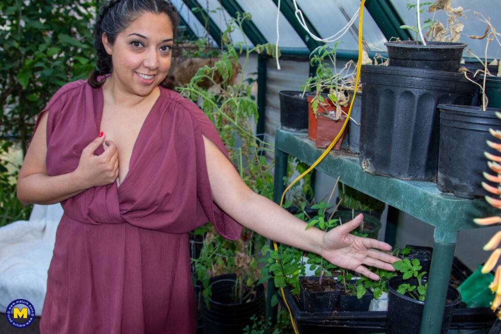 Chubby lady lets her hair down while disrobing to masturbate in a greenhouse - #2