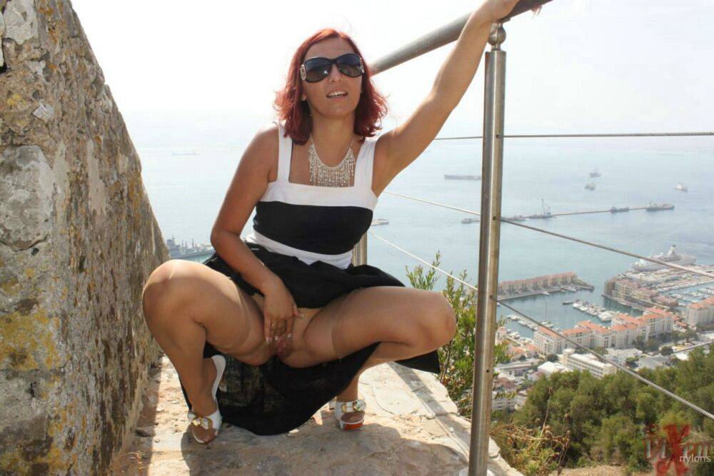 Solo girl flashes a no panty upskirt in nylons while on vacation in Gibraltar - #10