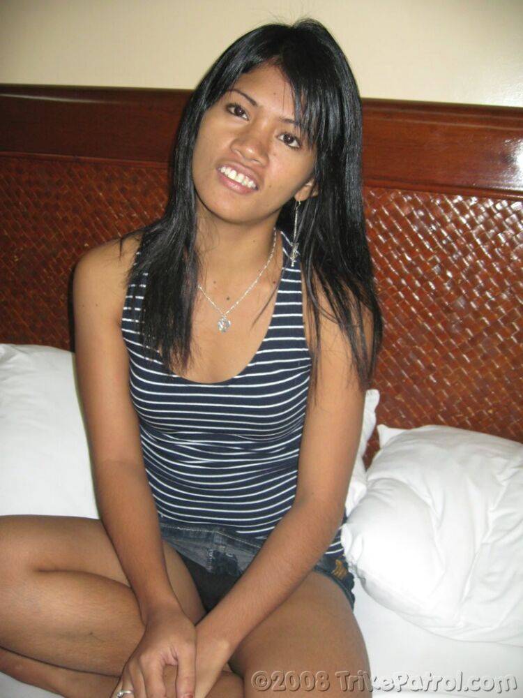 Cute Filipina girl strips to a black strapless bra and thong on a bed - #10