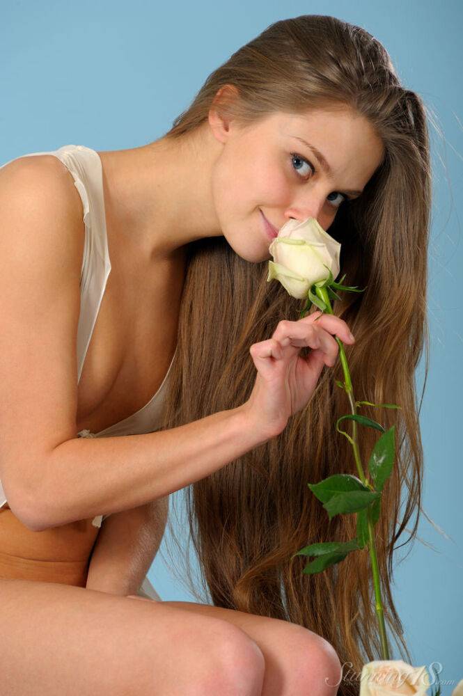 Sweet young girl Kristel A sniffs the flowers before modelling in the nude - #13