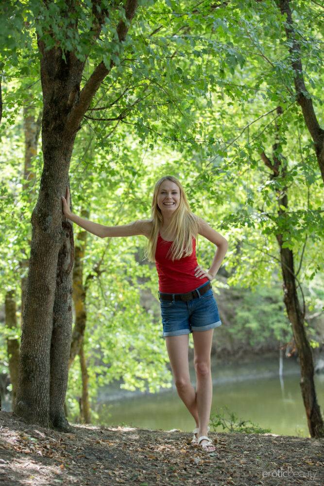 Young blonde Maria Rubio showcases her bald twat on a stump by a river - #4