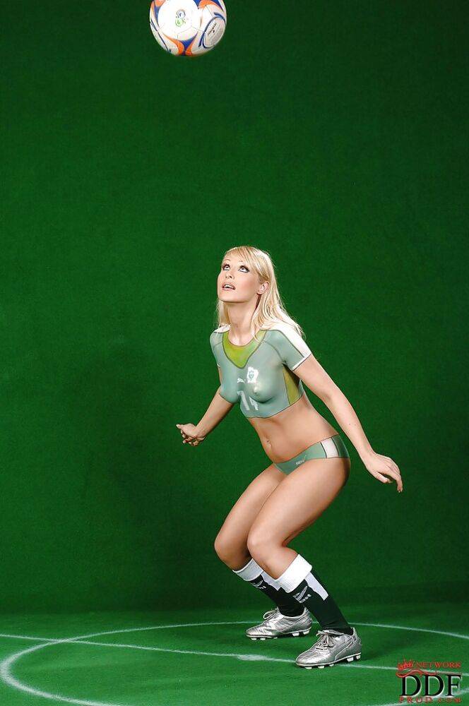 Graceful sporty babe posing in a body painted football uniform - #10