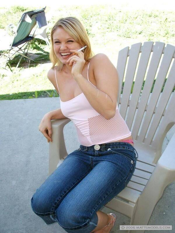 Cute blond girl smokes a cigarette before unleashing her natural tits in jeans - #16