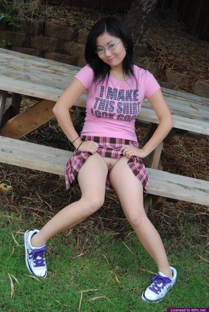 Asian teen Chiyo hikes up her skirt to show her ass and twat on a picnic table - #3