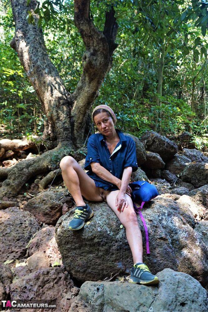 Mature amateur Diana Ananta sports a no panty upskirt while hiking in a forest - #5