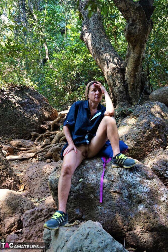 Mature amateur Diana Ananta sports a no panty upskirt while hiking in a forest - #11