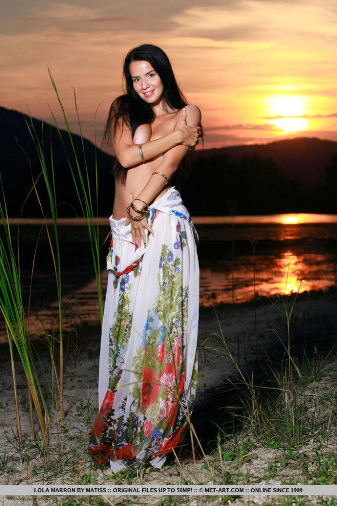 Dark-haired teen Lola Marron slips out of a long dress to pose nude at sunset - #2