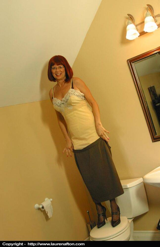 Classy mature woman Miss Abigail stands on a toilet seat to start stripping - #12