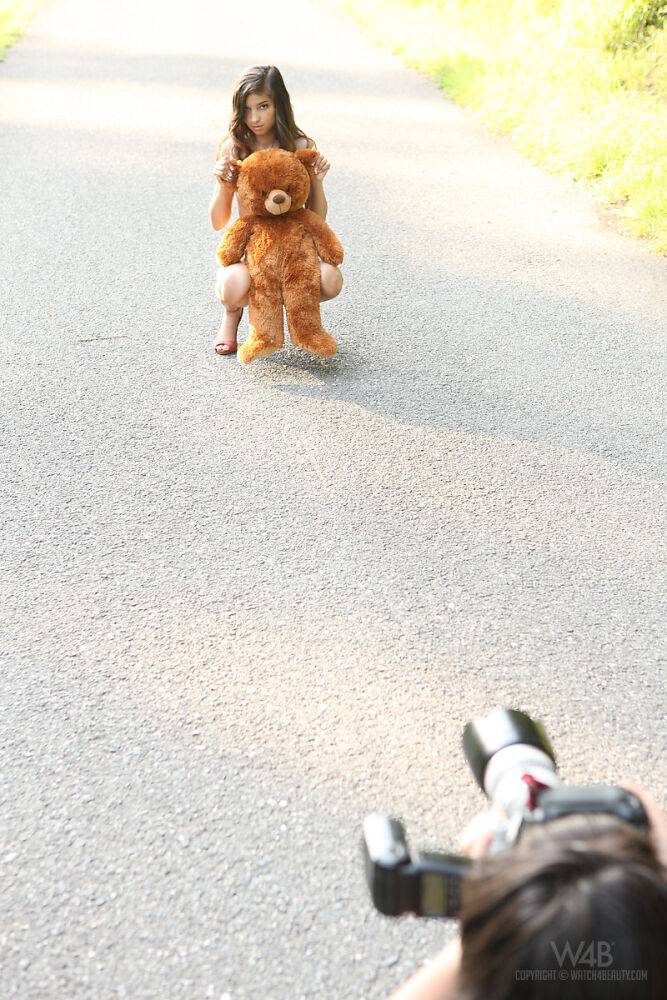 Young looking teen Nika poses naked on a road with a stuffed bear - #15