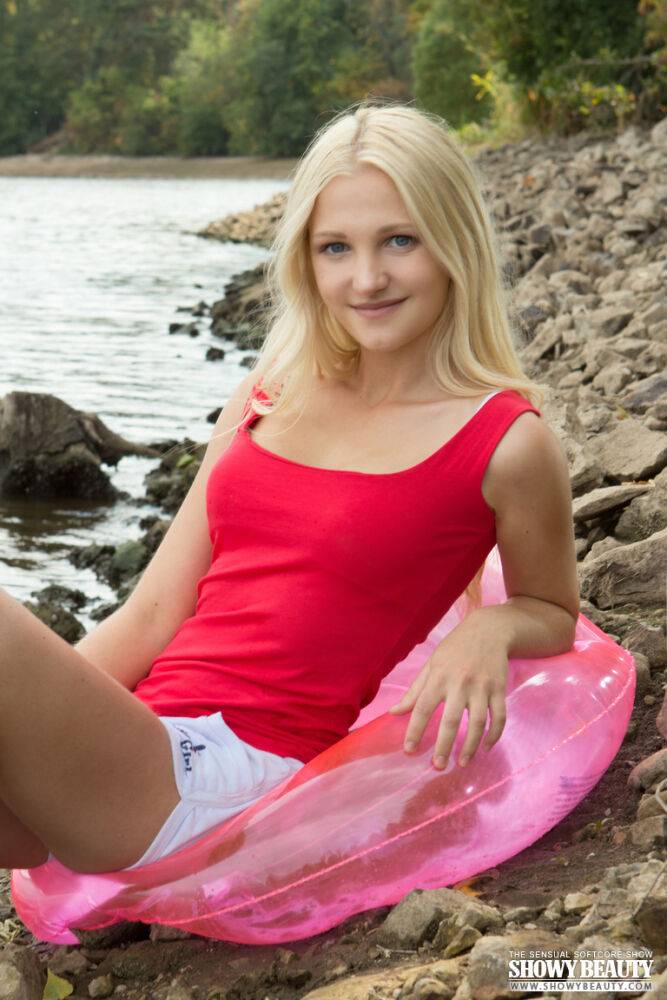 Petite blonde teen shows off her A cup tits and bald twat on rocky shoreline - #1