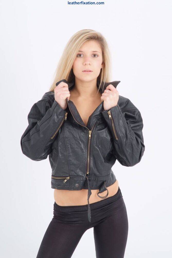 Blond chick unzips her leather jacket in a black bra and leggings - #7