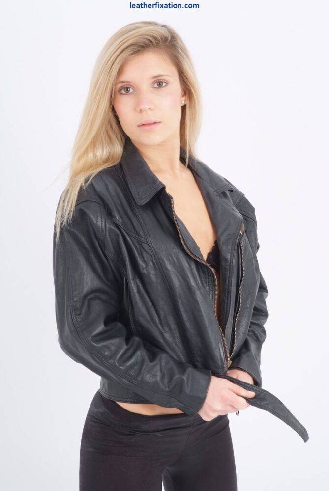 Blond chick unzips her leather jacket in a black bra and leggings - #10