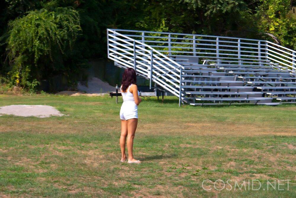 First timer Kerein covers her naked boobs in front of bleachers at a park - #5