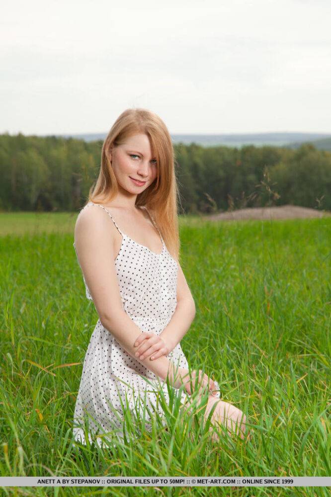 Fair skinned teen Anett A shows her naked beauty in a field of green grass - #15