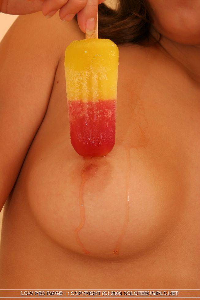 Pretty young girl licks a frozen treat while getting totally naked on her bed - #13