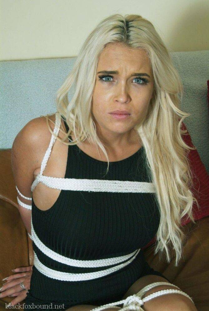 White female with long blonde hair is tied up with rope in a black dress - #5