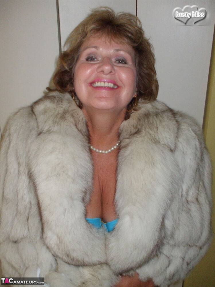 Mature amateur Busty Bliss exposes her tan lined tits while wearing a fur coat - #9