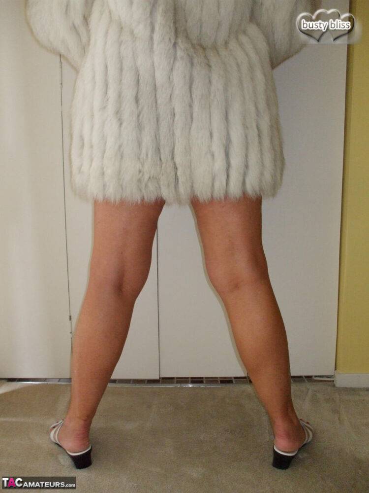 Mature amateur Busty Bliss exposes her tan lined tits while wearing a fur coat - #8