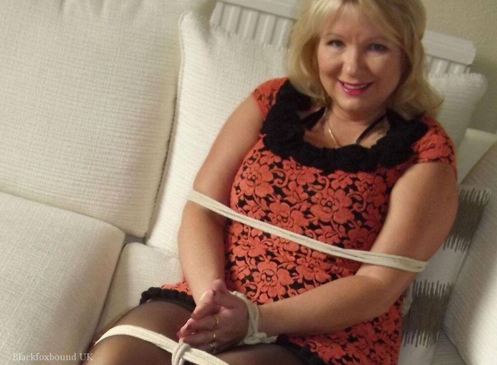 Blonde female is cleaved gagged and tied with rope in a number of dresses - #10