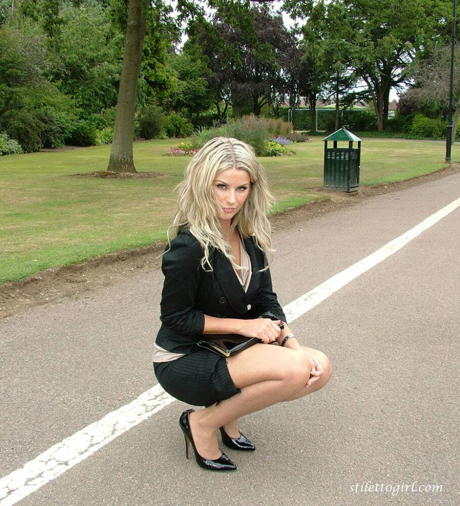 Clothed blonde secretary shows off her legs and pumps in a public park - #12