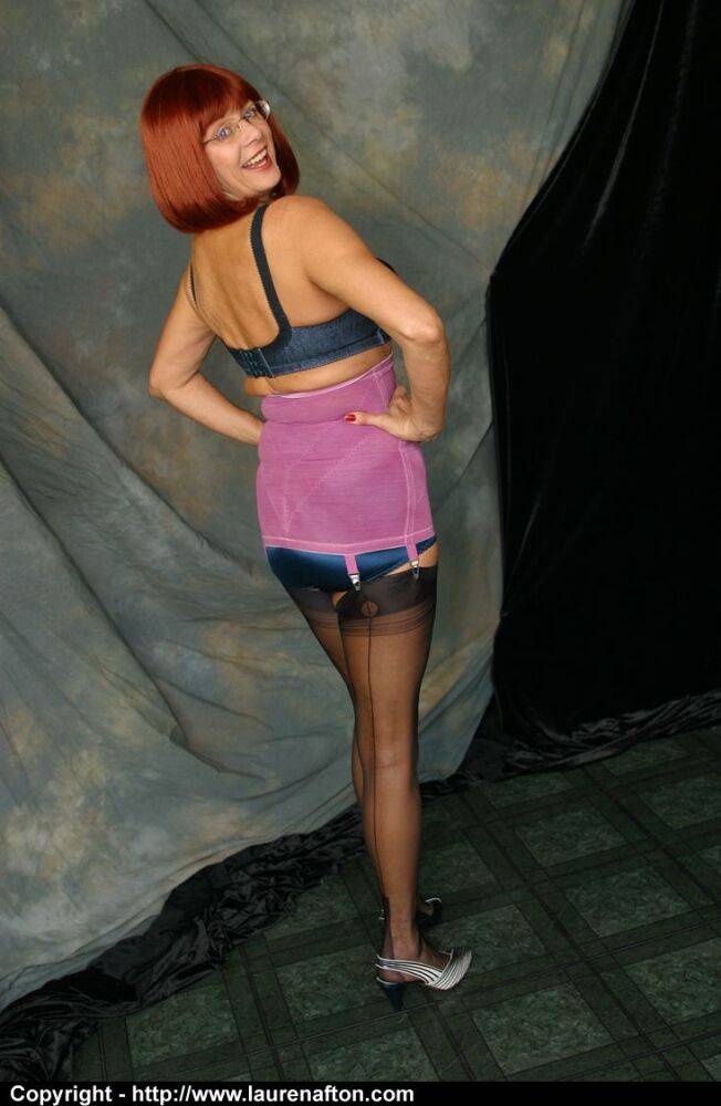 Older redhead Miss Abigail strips to a girdle and back seam nylons - #3